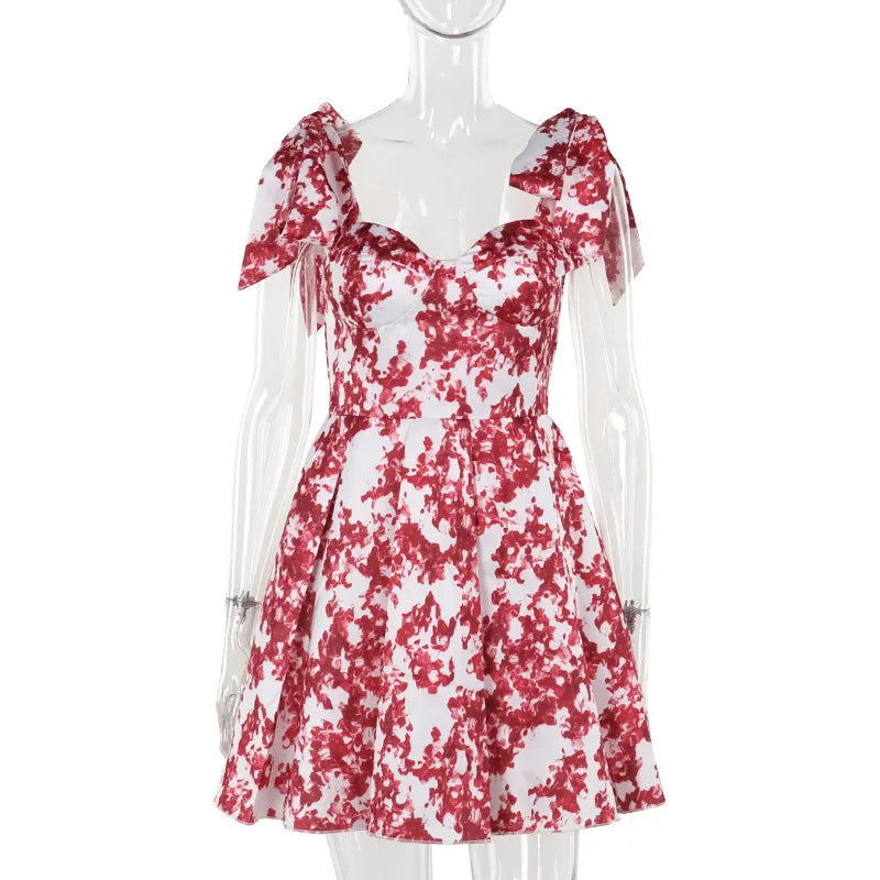 Imprimé floral de vacances d'été ; mignon et élégant ; mini robe trapèze à épaules dénudées ; mode nouée ; robe de soirée pour femme.